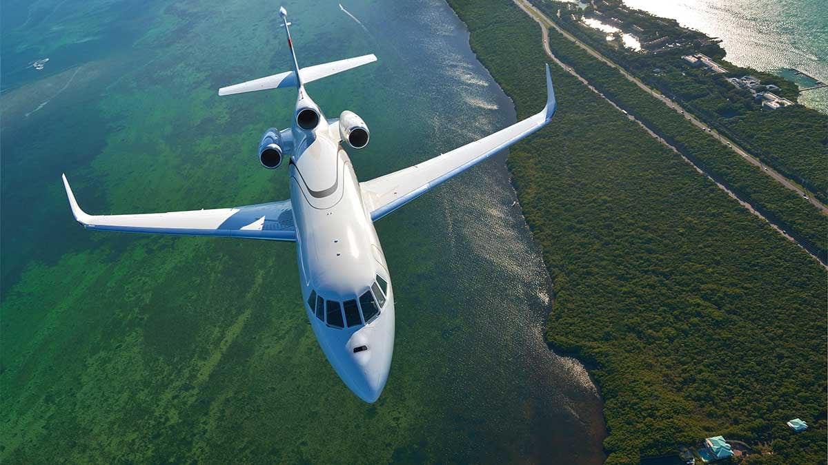 Dassault Falcon 900LX in flight over water