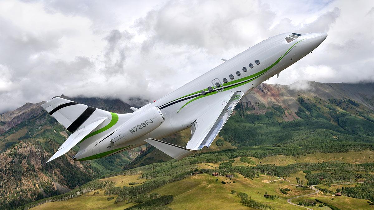 Dassault Falcon 200S flying over mountains