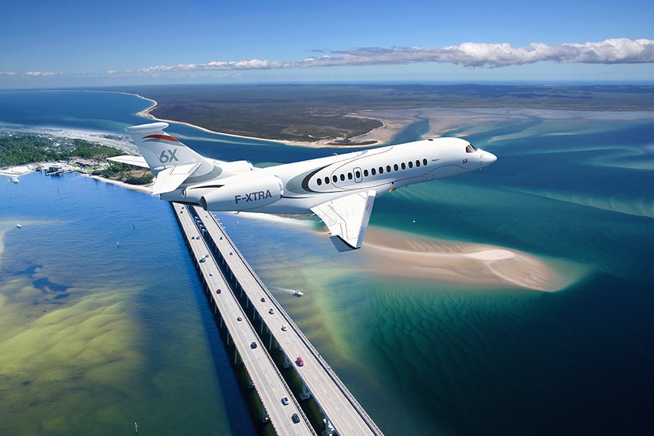 Dassault Falcon 6X flying over highway