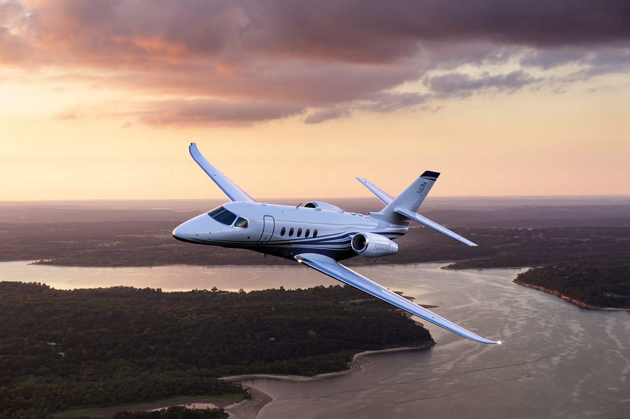 Cessna Citation Latitude private jet flying at dusk