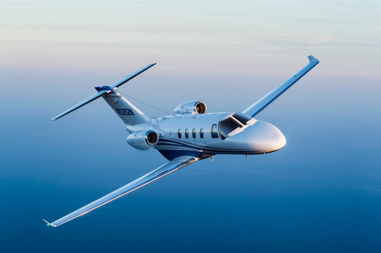 Cessna Citation M2 flying over water 