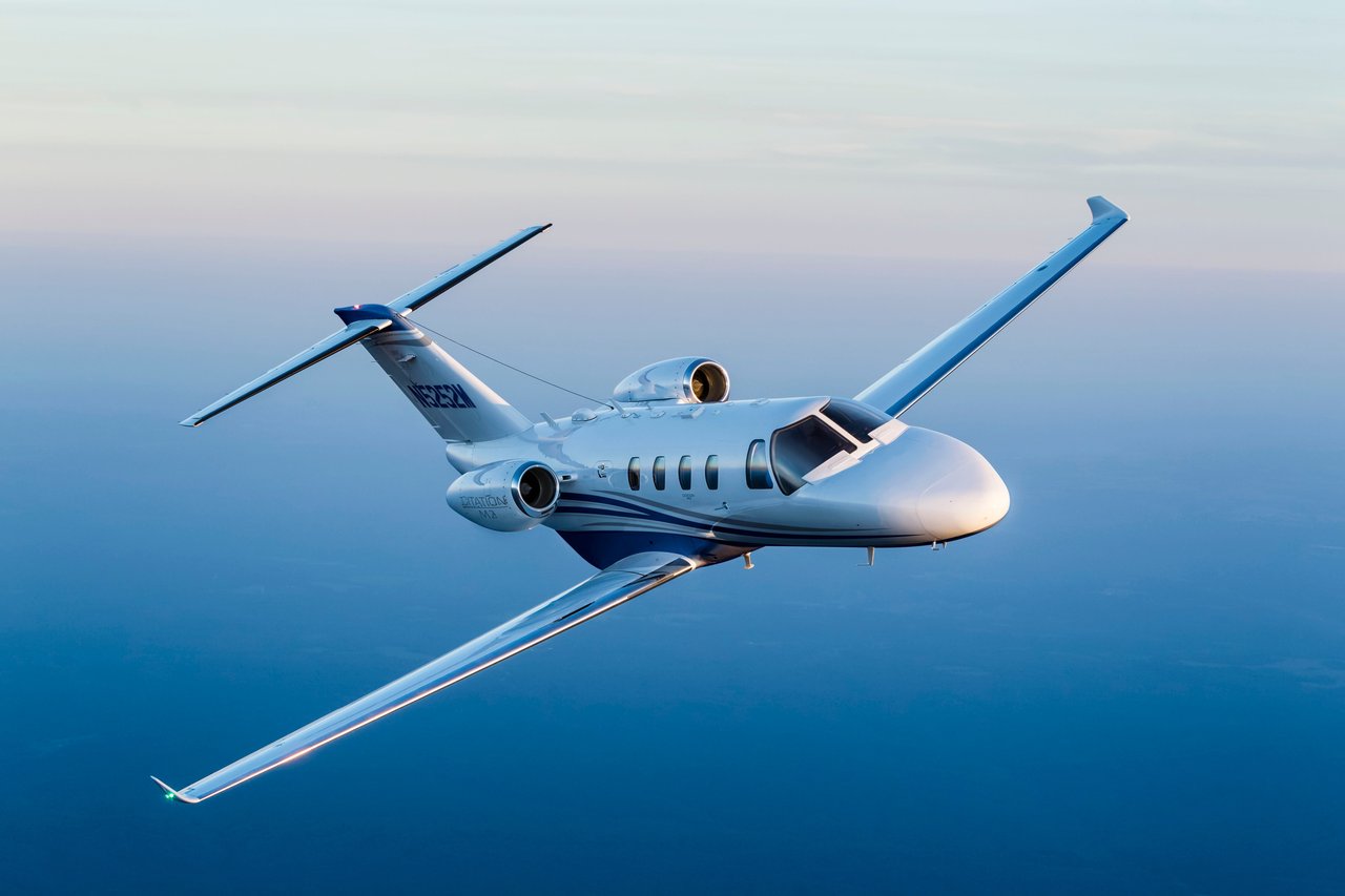 Cessna Citation M2 flying over water 