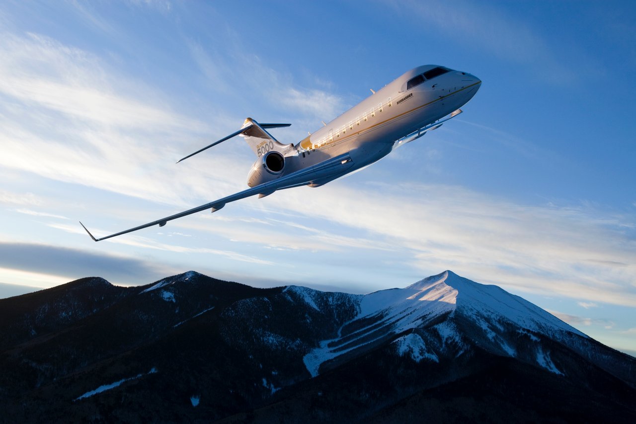 bombardier global 5000 above mountain peak