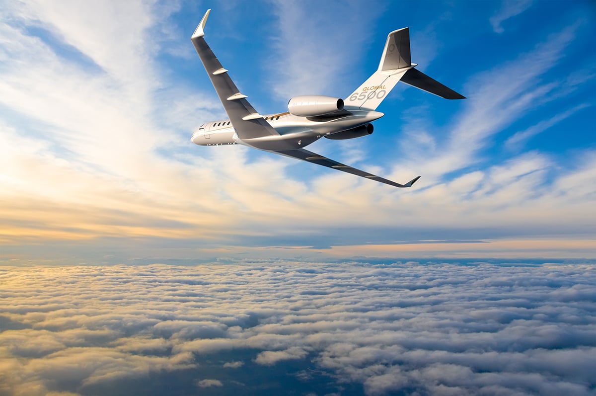 Bombardier global 6500 in flight at sunset