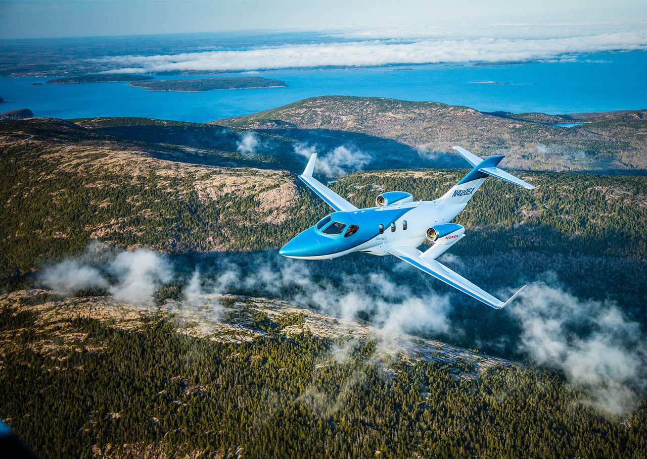 corporate hondajet elite flying over mountains